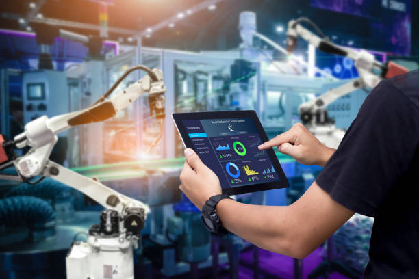 Hands holding tablet on blurred automation machine as background Hands holding tablet on blurred automation machine as background